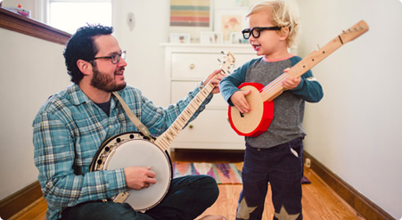 man playing instrument with child